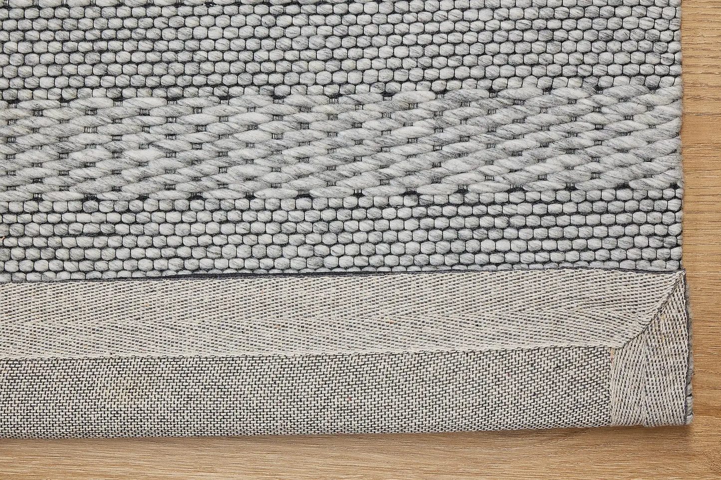 Albi Silver is a Silver and Black, PET Yarn (recycled Plastic) Hand woven flatweave rug. Sizes 160 X 230, 200 X 290 and 240 x 340. Fold.