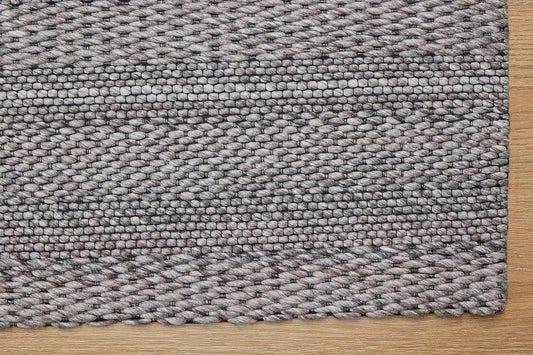Albi Taupe is a Beige/Grey and Black, PET Yarn (recycled Plastic) Hand woven flatweave rug. Sizes 160 X 230, 200 X 290 and 240 x 340. Corner.