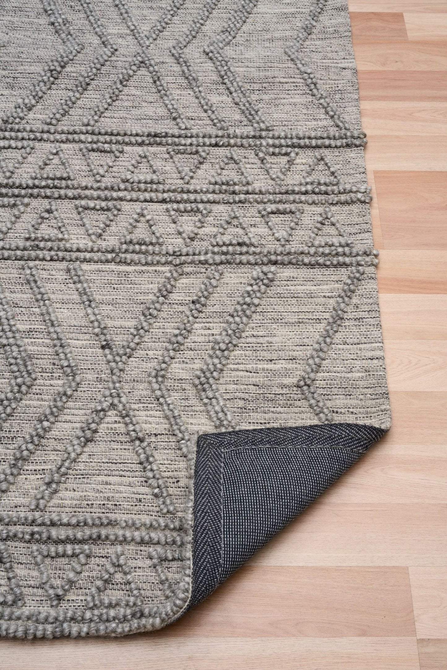 Anita-2 Grey is a hand woven textured wool rug. Featuring a tribal geometric design. Colour Charcoal. Sizes 155 X 225, 200 X 290, 240 X 340 and 300 X 400. Fold.