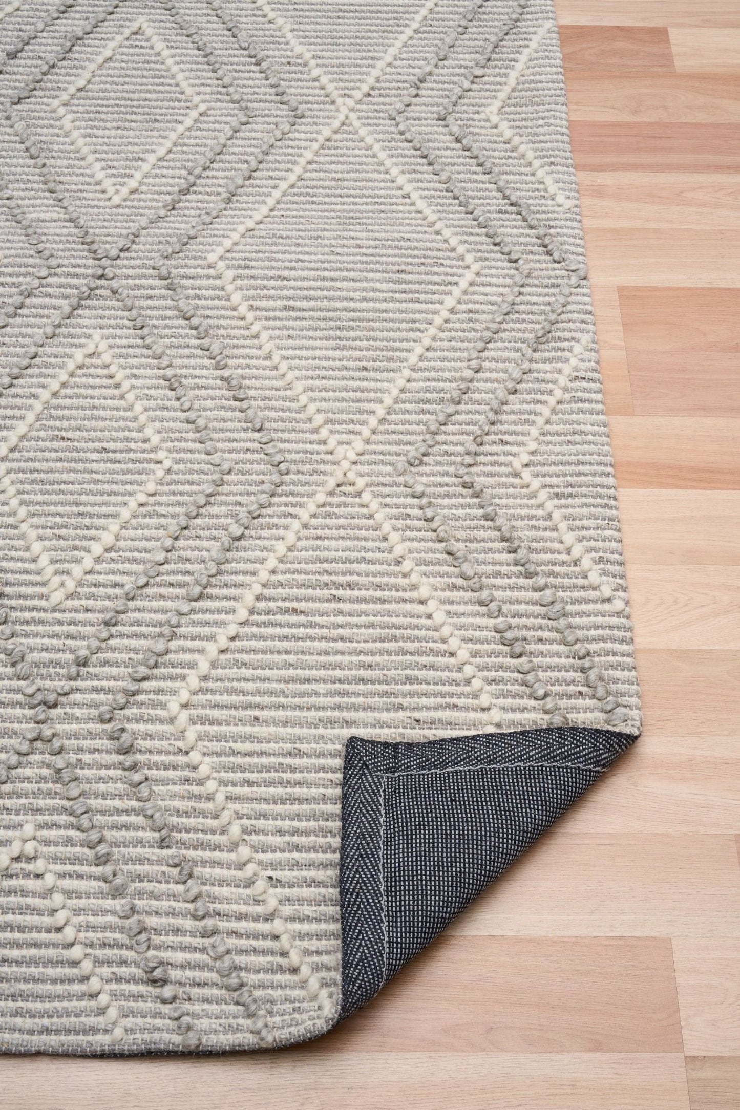 Anita Silver is a hand woven textured wool rug. Featuring a tribal geometric design with a 6-8mm pile height. Colour Silver Grey, Grey and White. Sizes 155 X 225, 200 X 290, 240 X 320 and 300 X 400. Fold.