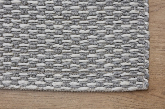 Ankara Silver is a Hand-woven, loop-textured rug crafted from a luxurious combination of wool and bamboo silk. Colours Silver and Grey. Sizes 160 X 230, 200 X 290, and 240 X 340. Corner.