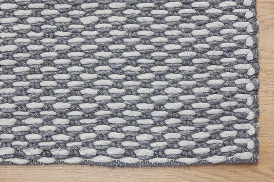 Ankara Smoke is a Hand-woven, loop-textured rug crafted from a luxurious combination of wool and bamboo silk. Colours Dark Grey and Light Grey. Sizes 160 X 230, 200 X 290, and 240 X 340. Corner.