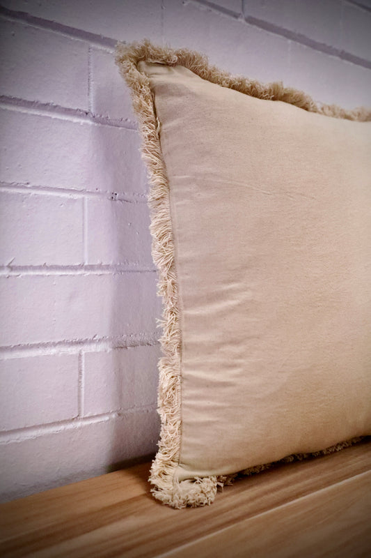 Our Antique Cream, cushion is hand crafted in India by skilled artisans. Features a soft feel, with small fringes around the edges. Colour Cream. Sizes 50 X 50 and 60 X 60. Angle.