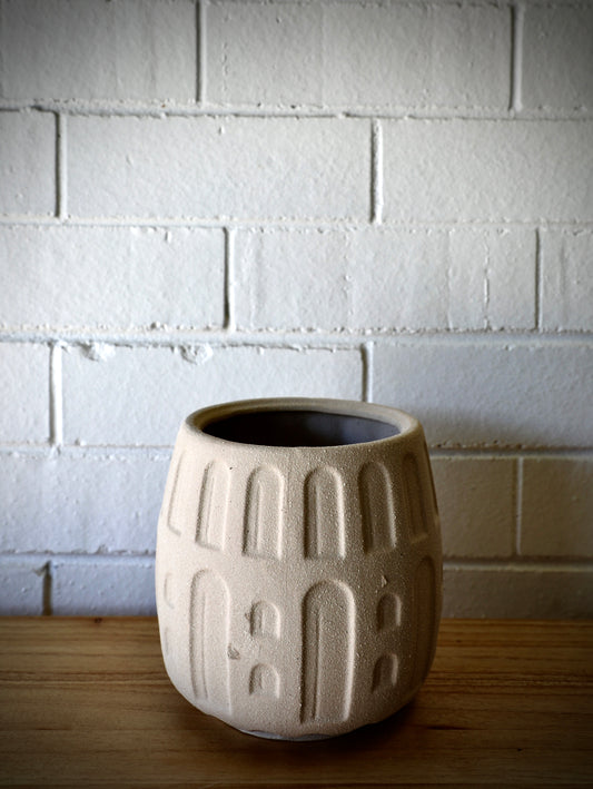 The Archer Ceramic Pot, simplistic comtemporary style. With its slight textured sides and neutral tones it will be a good choice for any area. Colour White/Cream. Measures 16 Diameter X 16 Height. Plain.