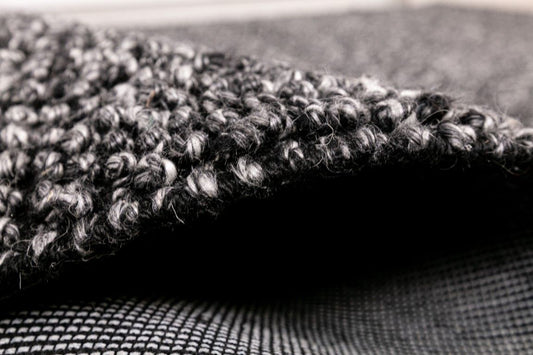 Avenue Charcoal is a hand woven PET Yarn (Recycled Plastics) Rug. It features a soft wool-like feel with a modern/contemporary design. Colour Charcoal. Sizes 155 X 225, 200 X 290, 240 X 320 and 300 X 400. Side.