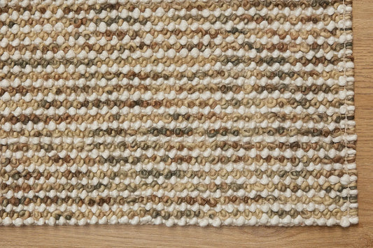 Avila - Beige is a handwoven loop piled carpet. It features a blend of fine wool and viscose, with a pile height of 16-18mm. Colours Beige with Brown accents. Sizes 160 X 230, 200 X 290, 240 X 340 and 300 X 400. Corner.