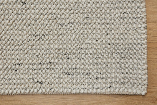 Avila - Natural is a handwoven loop piled carpet. It features a blend of fine wool and viscose, with a pile height of 16-18mm. Colours Cream with Brown and Beige accents. Sizes 160 X 230, 200 X 290, 240 X 340 and 300 X 400. Corner.