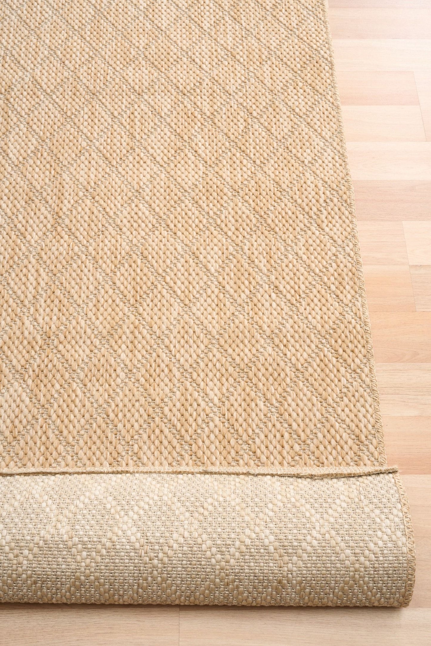 Barton Diamond Beige indoor/outdoor rug featuring soft beige tones and a subtle textured pattern, power-loomed from UV-stabilised polypropylene for lasting durability. Colour Beige. 3 sizes. Fold.