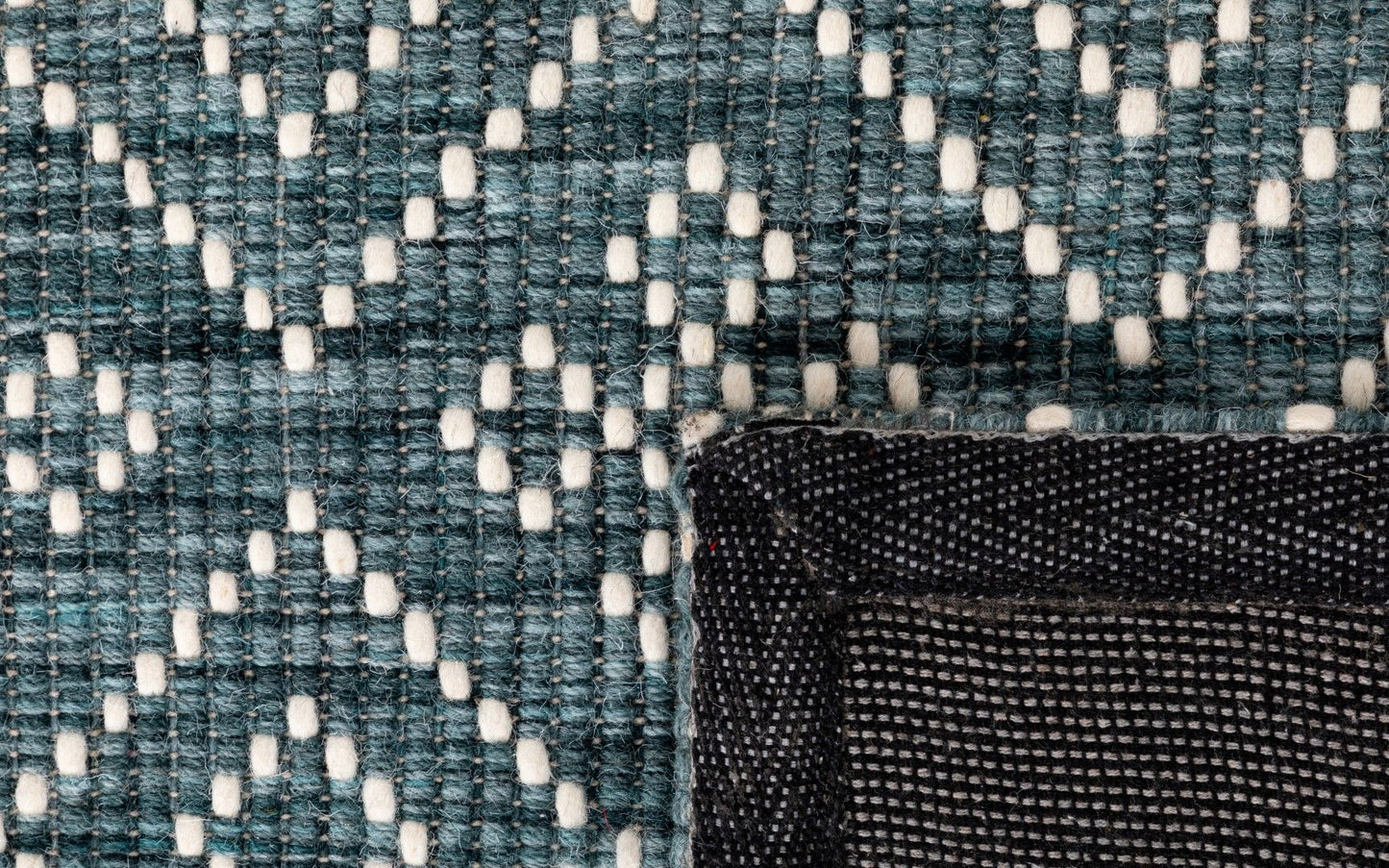Bellevue Teal is a textured hand woven wool and viscose rug. Featuring a tribal diamond aztec design. Colours Teal Green with White Patterns. Sizes 200 X 290 and 300 X 400. Fold.