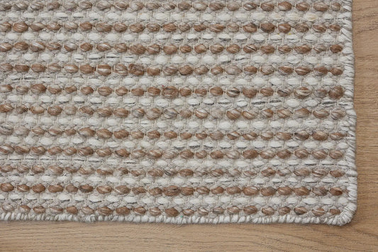 Boa - Natural is a hand-woven flatweave, made of wool with a pile height of 7-9mm. Colours Cream with Beige accents. Sizes 160 X 230, 200 X 290, and 240 X 340. Corner.