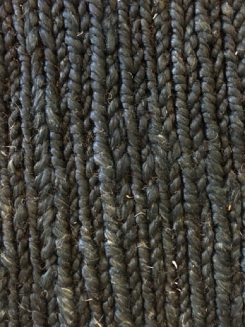 Byron Black hand-woven hemp rug in a braided-style flatweave. Black. Sizes 200 x 290 and 240 x 320 cm. Top close view.