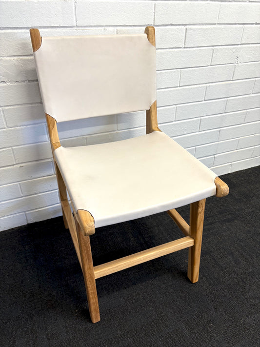 The Cherokee - White Dining Chair is crafted from solid teak with a smooth white leather seat and back. Colours natural frame with white seat and back. Measures 560 Depth x 450 Wide x 500 Seat Height. Back height 820. Angle.