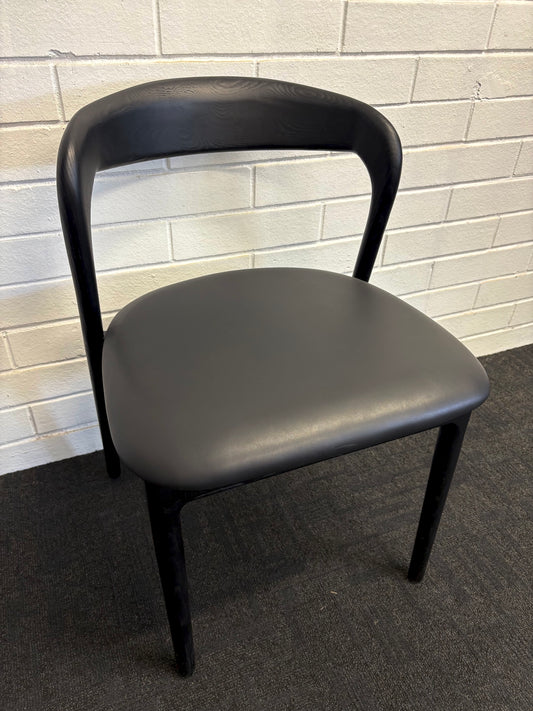 The Cheyenne Black dining chair features a modern style and design. Crafted with a solid ash frame and a smooth padded Black polyurethane seat. Colour Black Frame with black seat. Measures 500 wide X 520 depth X 460 Seat height. Back height 750. Angle.