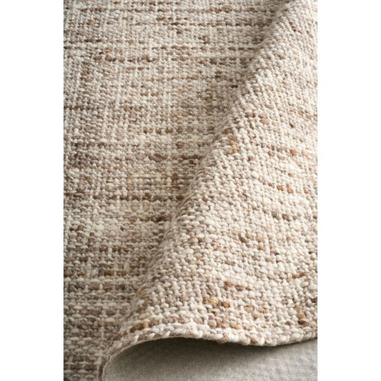 Cleo Brown hand-woven wool flatweave rug in a warm rust tone, with a flecked, cross-woven texture and flat woven border. 3 sizes. Roll view.