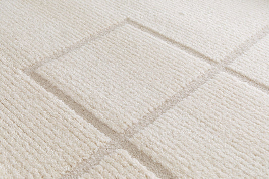 Cocoon - Cream, a modern rug design crafted with a unique blend of Heat Set Polypropylene and Polyester shrink yarn. Top Close.