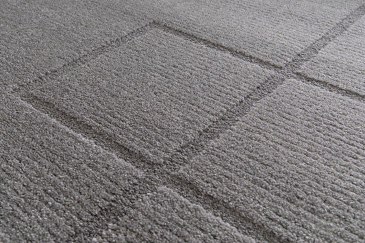 Cocoon - Grey, a modern rug design crafted with a unique blend of Heat Set Polypropylene and Polyester shrink yarn. Top Close.