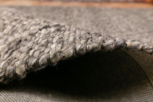 Colombo Dark Grey is a textured hand woven rug. Made from 80% wool and 20% polyester, it features a braided diamond pattern for an extra textured feel. Colour Dark Grey. Sizes 155 X 225, 200 X 290, 240 X 320 and 300 X 400. Side.