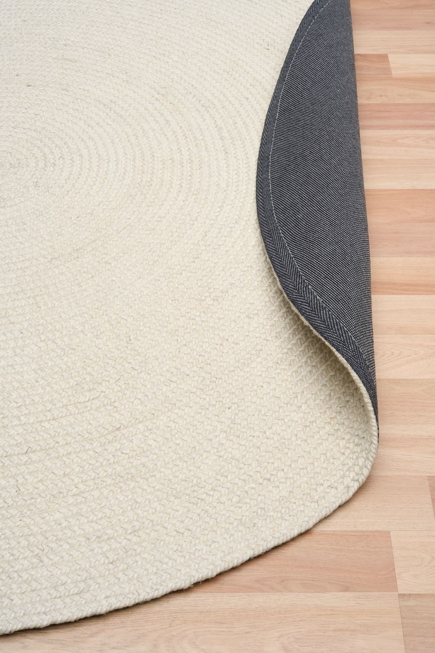 Cora Round Ivory Rug hand woven from 70% New Zealand wool and 30% viscose in a braided weave. Colour Ivory. 2 sizes, 200cm round and 250cm round. Fold View.
