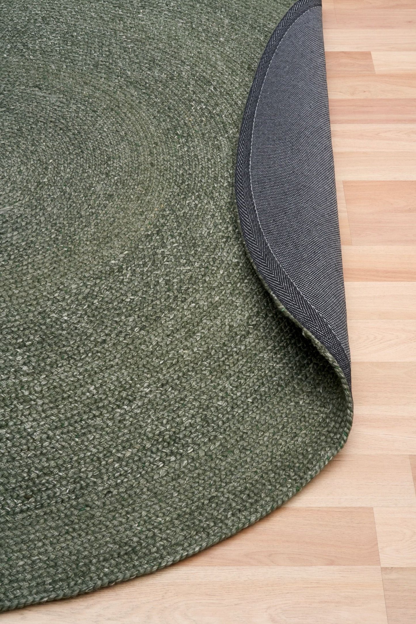 Cora Round Olive Rug hand woven from 70% New Zealand wool and 30% viscose in a braided weave. Colour Dark Olive. 2 sizes, 200cm round and 250cm round. Fold View.