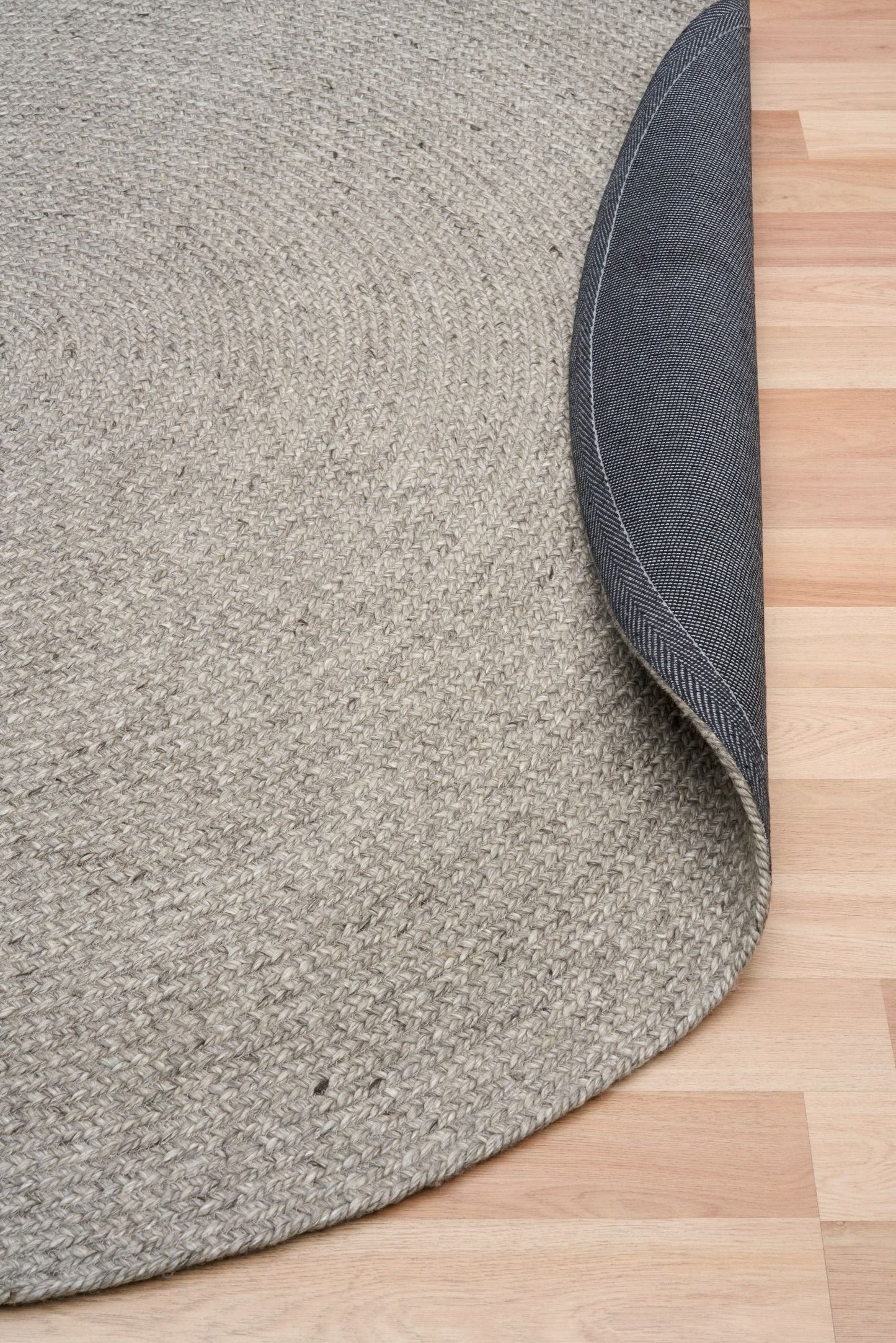 Cora Round Silver Rug hand woven from 70% New Zealand wool and 30% viscose in a braided weave. Colour Silver Grey. 2 sizes, 200cm round and 250cm round. Fold View.