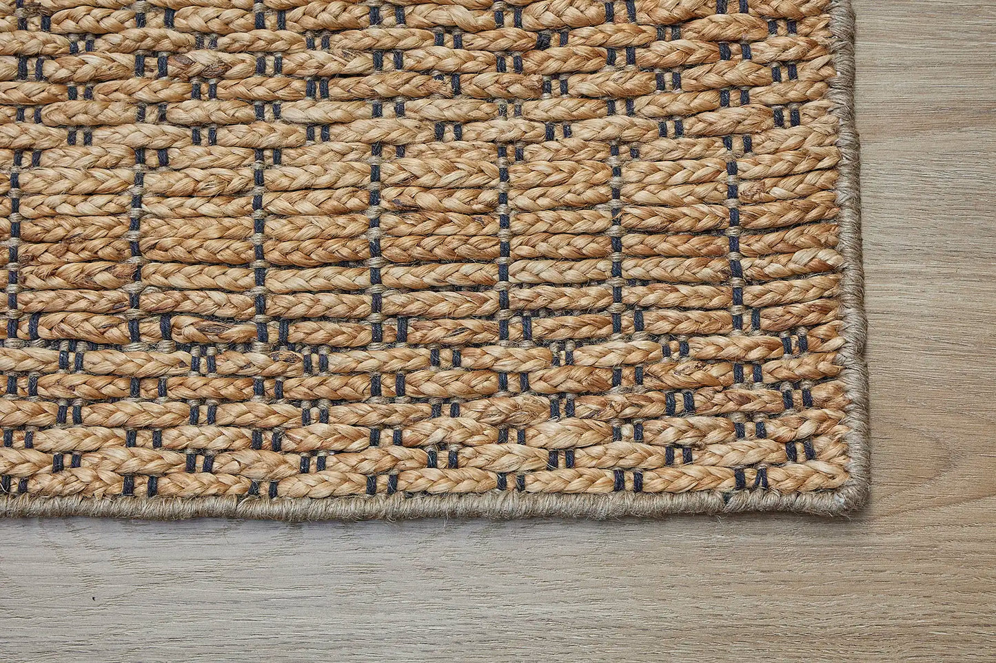 Daintree - California is a rug made with panja hand woven natural coloured jute. Features a 7-9mm pile height. Colour Natural with Black. Sizes 160 X 230, 200 X 290 and 240 X 340. Corner.