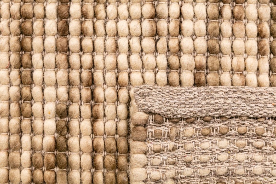 Dasha Natural is a texture hand woven rug made of 80% New Zealand Wool and 20% Polyester. Colour Beige with Brown accents. Size 300 X 400. Fold.