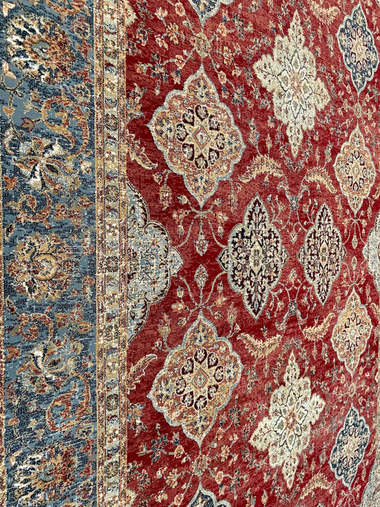 The Davinci Heriz Red Persian Rug. Machine made and crafted from durable heat-set polypropylene. The classic Persian design will elevate your home decor. Colours, reds, blues, beiges. 4 Sizes. Close Angle.