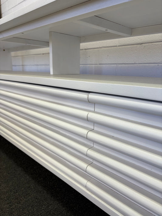 The Dean White 2400 Entertainment Unit features a floating top shelf. With 3 textured drawers and stylish turned legs. Colour White. Measures 2400 Length X 400 Depth X 650 Height. Angle.