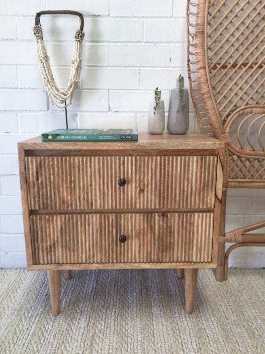 The Denali 2 Drawer bedside is a contemporary designed bedside. It features 2 drawers with a textured front and is crafted from sustainable fruitwood. Colour natural. Measures 600 wide X 350 depth X 610 height. Front Styled.