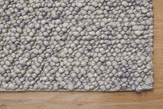 Dunes Pigeon is a hand-braided wool rug, giving it a textured, luxurious feel. With a 16-18mm pile height. Colour Light blues and white. Sizes 160 X 230, 200 X 290 and 240 X 340. Corner.