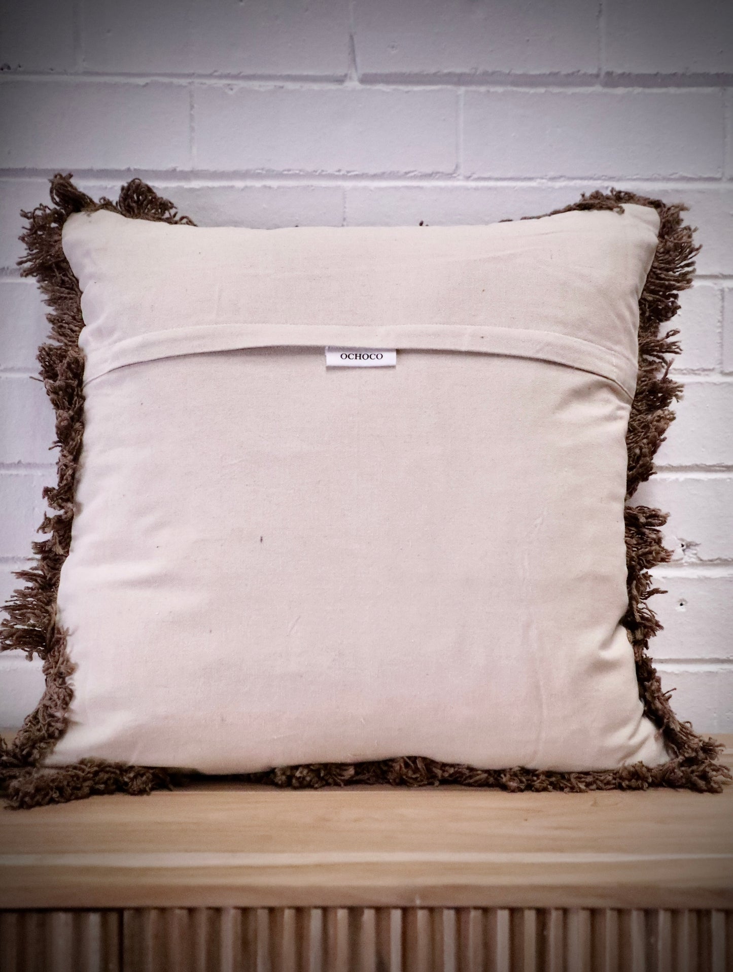 The Earthy, brown, throw cushion is crafted from skilled artisans in India. Made of Cotton Slub which is a cotton fabric with a textured feel. Colour brown. Sizes, 50 X 50 and 60 X 60. Back.