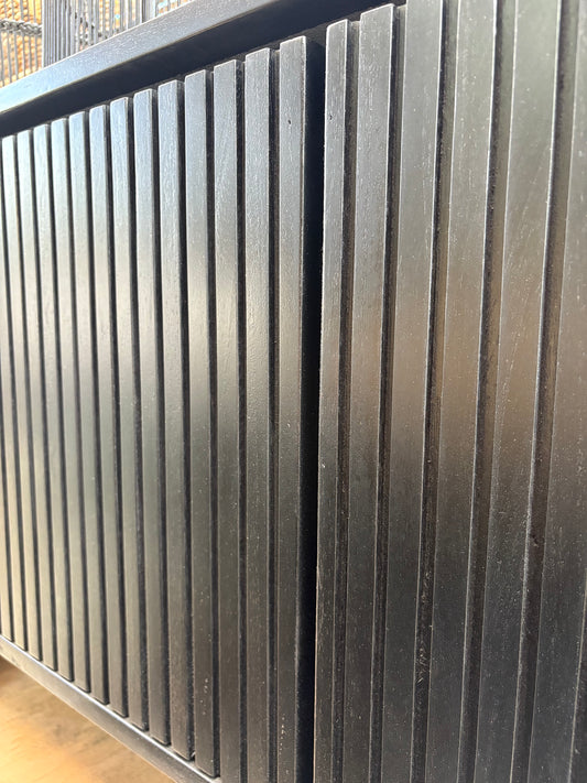 The Eastwood Black Entertainment Unit. 4 textured doors with smart storage behind the left door featuring 3 drawer. Colour Black. Measures 1800 wide X 400 depth x 650 height. Close.