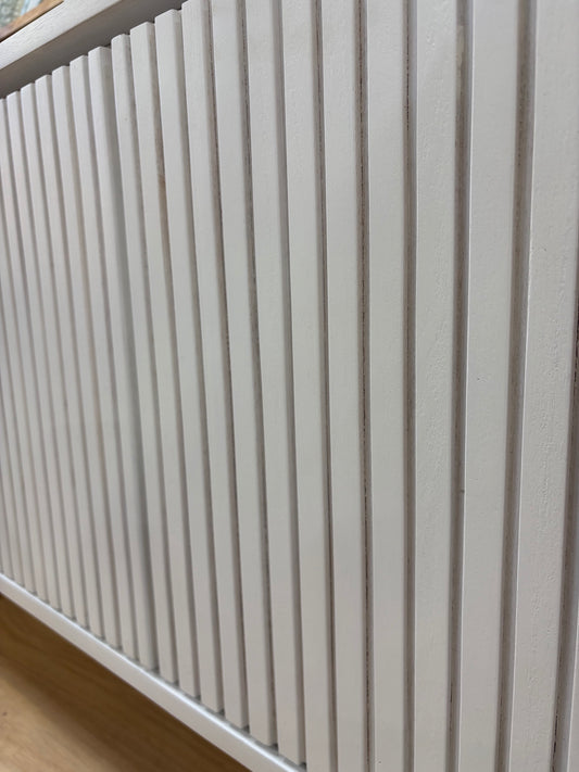 The Eastwood White Entertainment Unit. 4 textured doors with smart storage behind the left door featuring 3 drawer. Colour White. Measures 1800 wide X 400 depth x 650 height. Close.