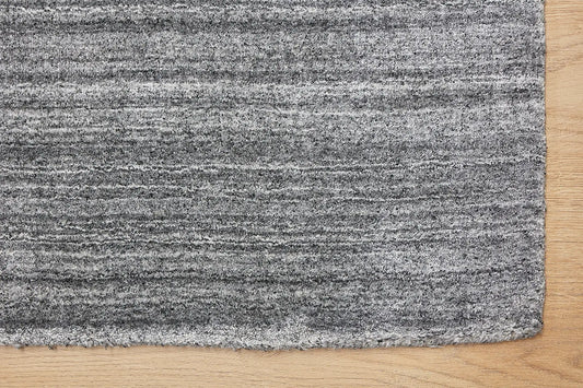 Ethnic Charcoal is a luxurious hand loomed carpet made of 80% wool and 20% bamboo silk. The finely crafted material creates a super soft texture and a smooth pile height of 16-18mm. Colour Charcoal. Sizes 160 X 230,, 200 X 290 and 240 X 340. Corner.