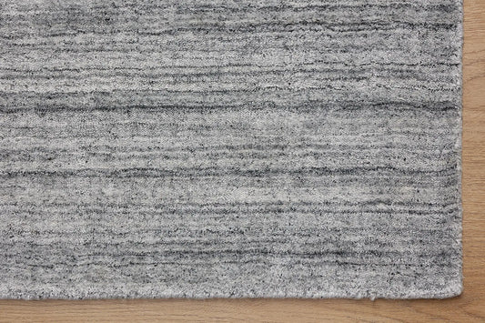 Ethnic Silver is a luxurious hand loomed carpet made of 80% wool and 20% bamboo silk. The finely crafted material creates a super soft texture and a smooth pile height of 16-18mm. Colour Silver. Sizes 160 X 230, 200 X 290 and 240 X 340. Corner.