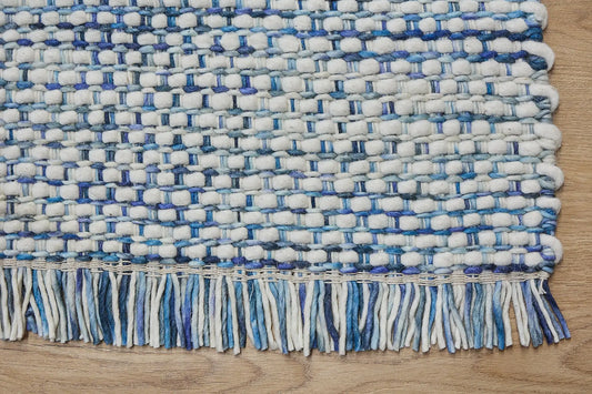 Fancy Mist is a hand braided wool rug with a sumptuous 12-14mm medium pile height. Colours White with blue accents. Sizes 160 X 230, 200 X 290, 240 X 340. Corner.