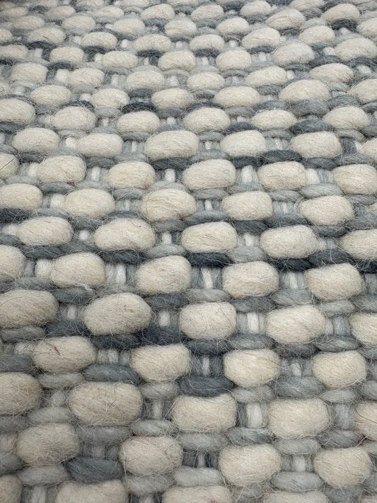 Fancy Grey is a hand braided wool rug with a sumptuous 12-14mm medium pile height. Colours White with greyish accents. Sizes 160 X 230, 200 X 290, 240 X 340. Close.