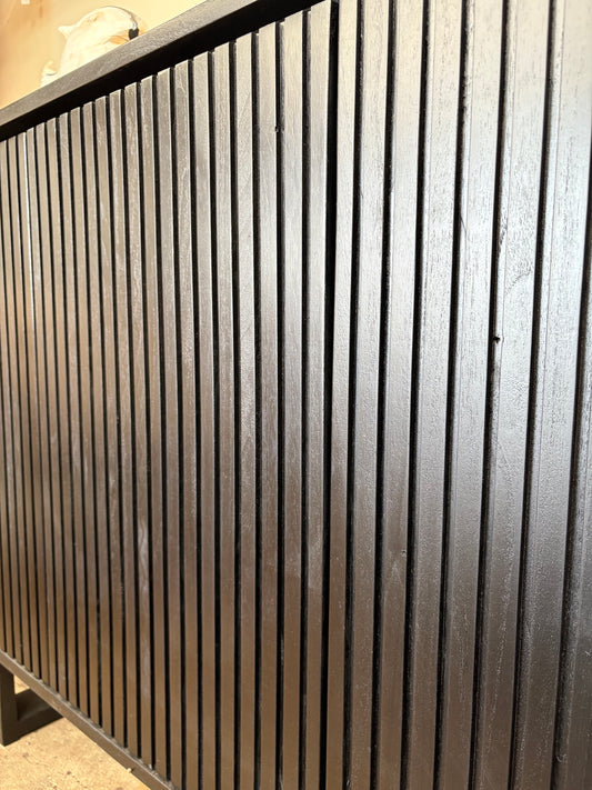 The Florence Black Buffet. 4 textured doors with smart storage behind the left door featuring 4 drawers. Colour Black. Measures 1800 wide X 400 depth x 900 height. Angle.