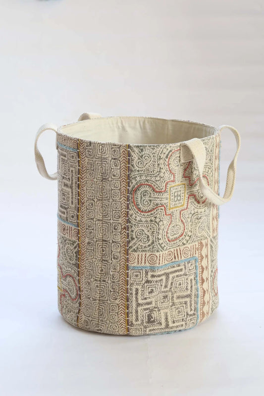 The Frosted Art Cotton Block Print Basket featuring a bold block print design and sturdy handles. Features a cotton liner and texture cotton outer shell. Colours, creams, browns, oranges, light blues. Measures 400 height X 350 diameter. Front Plain.