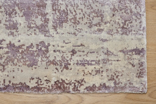 Fusion Lilac is a handcrafted rug made of luxurious bamboo silk and viscose. It features a textured, intricate, and opulent weave with a pile height of 12-14mm. Colours Cream, Beige and Lavender Blend. Sizes 160 X 230, 200 X 290 and 240 X 340. Corner.