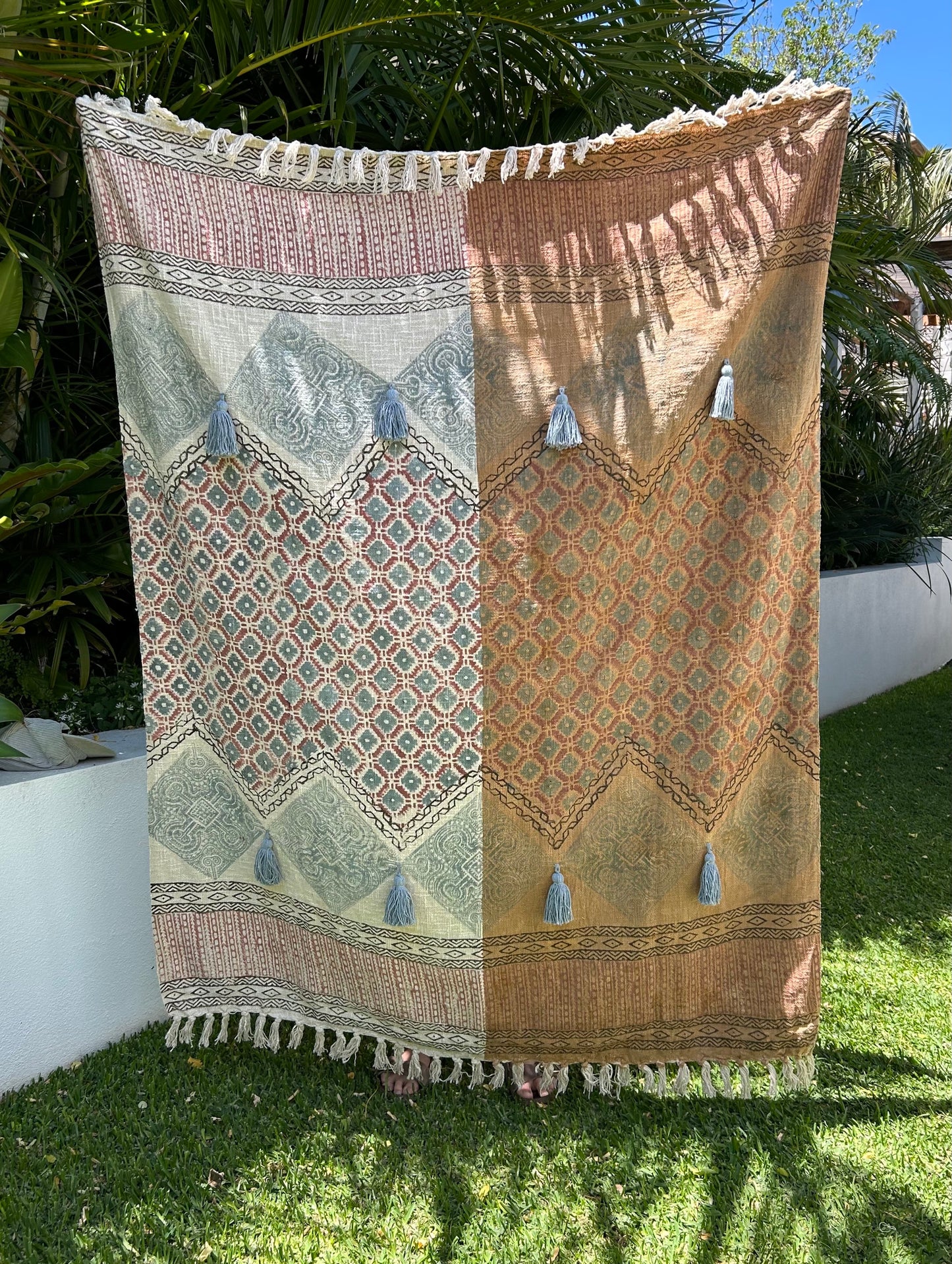 The Geo Throw Blanket is hand woven from soft cotton slub. The unique texture and tribal designs add a touch of bohemian charm. Colours orange, beige, blues and reds. Measures 130 wide x 170 length. Styled.