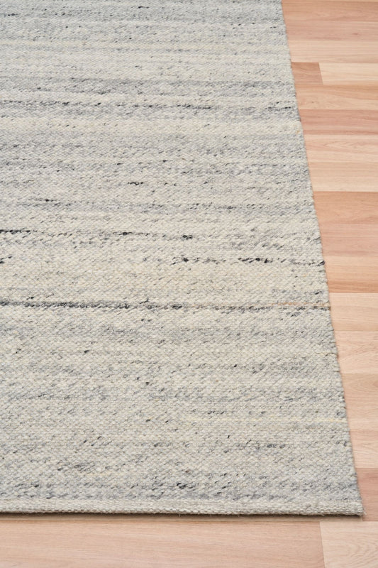 Harmony Grey Rug – hand-woven blend of wool and viscose in soft natural tones, featuring a textured finish that’s both elegant and durable. Colour White, Grey, black and brown flecks. 4 sizes. Corner.