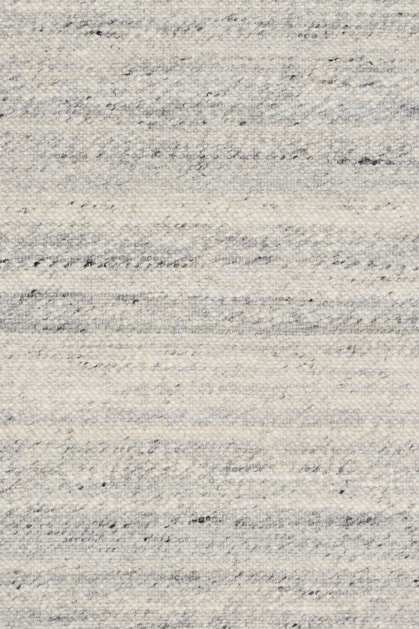 Harmony Grey Rug – hand-woven blend of wool and viscose in soft natural tones, featuring a textured finish that’s both elegant and durable. Colour White, Grey, black and brown flecks. 4 sizes. Close.