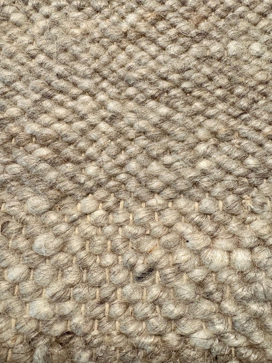 Harmony Grey Rug – hand-woven blend of wool and viscose in soft natural tones, featuring a textured finish that’s both elegant and durable. Colour White, Grey, black and brown flecks. 4 sizes. Up close.
