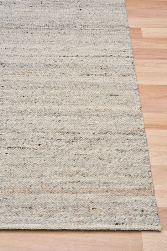 Harmony Smoke Grey Rug – hand-woven blend of wool and viscose in soft natural tones, featuring a textured finish that’s both elegant and durable. Colour White, Grey, black and brown flecks. 4 sizes. Corner.