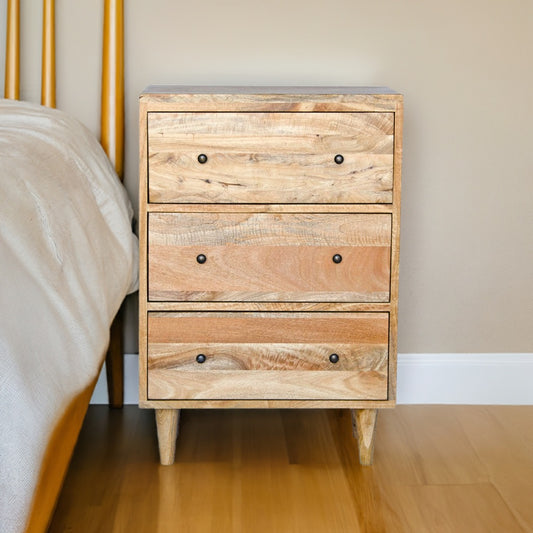 The Hood 3 Drawer Bedside is a contemporary designed nightstand. Crafted from fruitwood, it features 3 drawers with wooden drawer runners. Colour natural. Measures 610 wide X 400 depth X 900 height. Life.