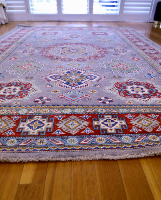 The Hand Knotted Kazak - 203 X 303. This wool rug combines superior durability with a traditional flair. 100% hand knotted wool. Measures 203 wide x 303 length. Angle.