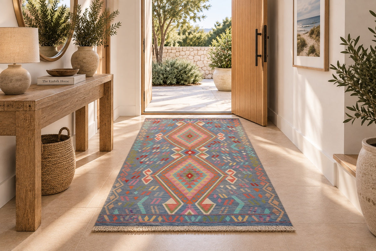 The Afghan Hand Woven Khyber Kilim - 130 X 193. Crafted using traditional vegetable dyed wool, and featuring traditional geometric designs. Colours, blues, lavenders, beiges, creams, oranges. Size 130 X 193. Life.