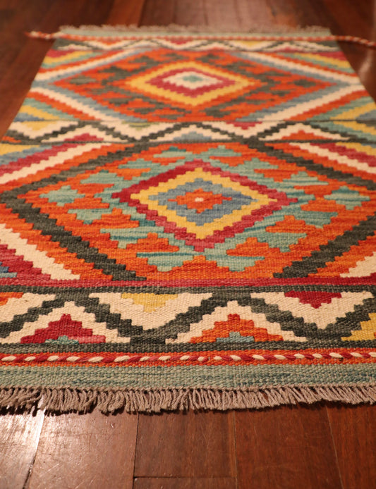 The Afghan Hand Woven Khyber Kilim - 65 X 90. Crafted using traditional vegetable dyed wool, and featuring traditional geometric designs. Colours, reds, beiges, creams, light greens, light blues and yellows. Size 65 X 90. Angle.