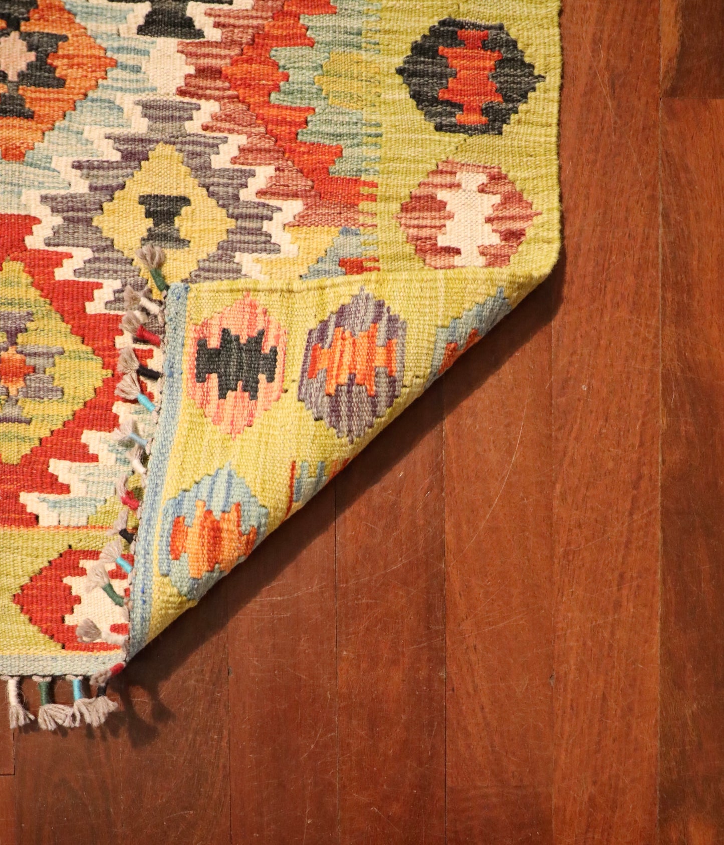 The Afghan Hand Woven Khyber Kilim Runner - 86 X 290. Crafted using traditional vegetable dyed wool, and featuring traditional geometric designs. Colours, yellows, creams, beiges, oranges, blues and more. Measures 86 wide X 290 long. Fold.